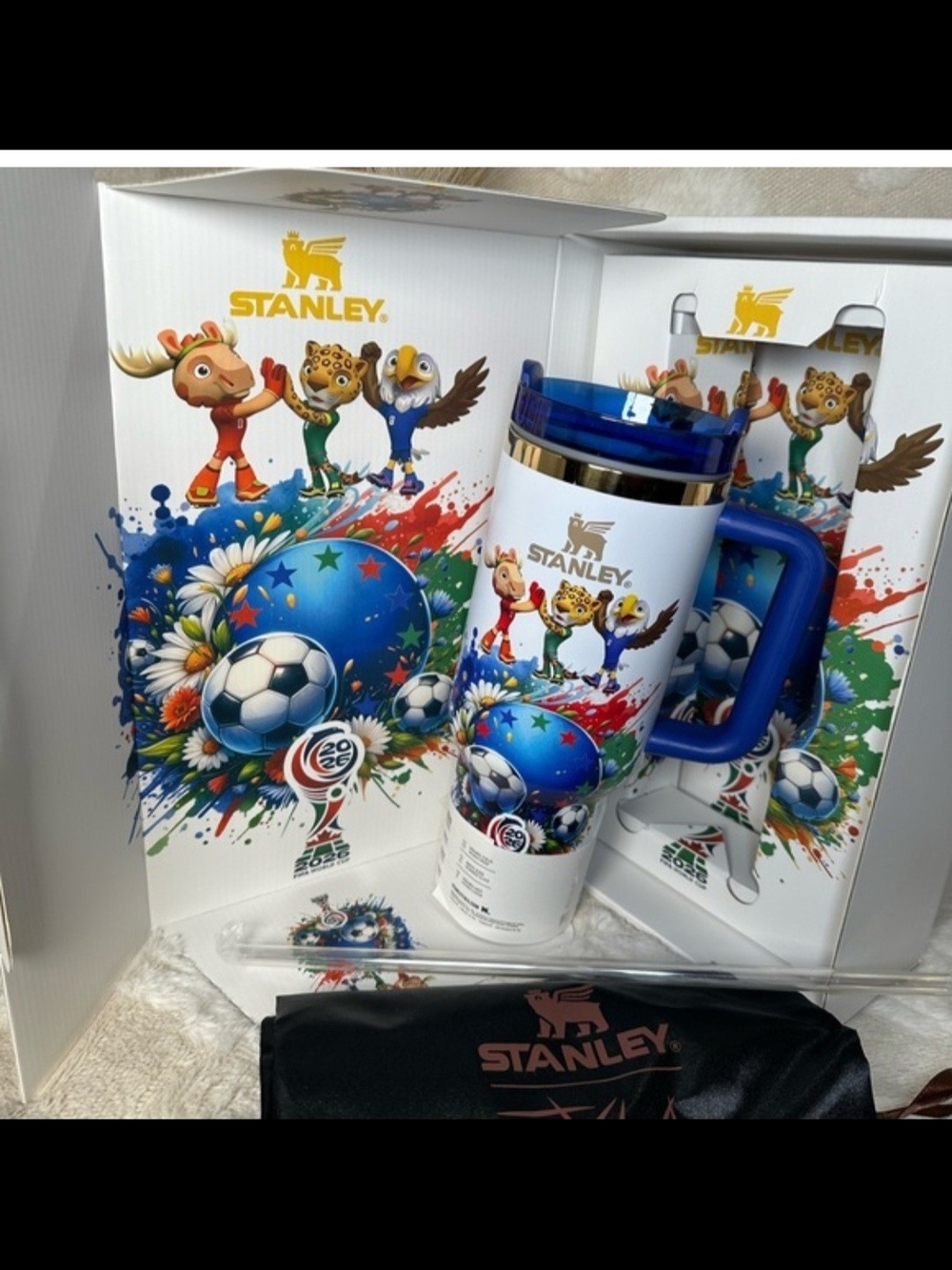 Stanley White Travel Mug with Blue Handle and Colorful World Cup Artwork